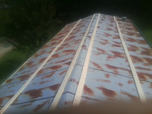 Rusted metal roof panels with new wood purlins before replacement — Storm Damage Roof Repair in Hermiston by Roofing Brothers