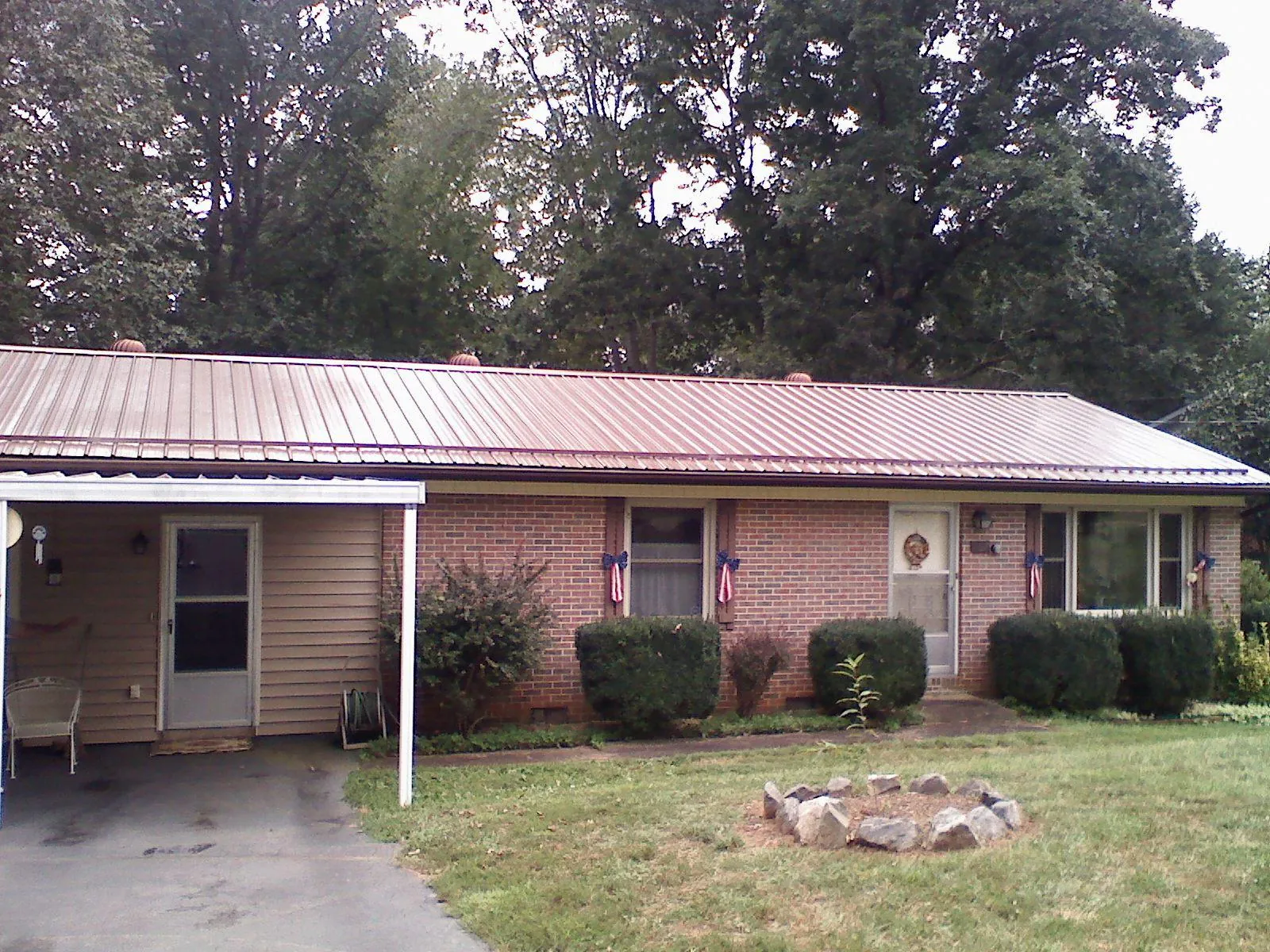 Bronze metal roof and carport on a brick ranch home — Roof Repair work by our crew in Hermiston