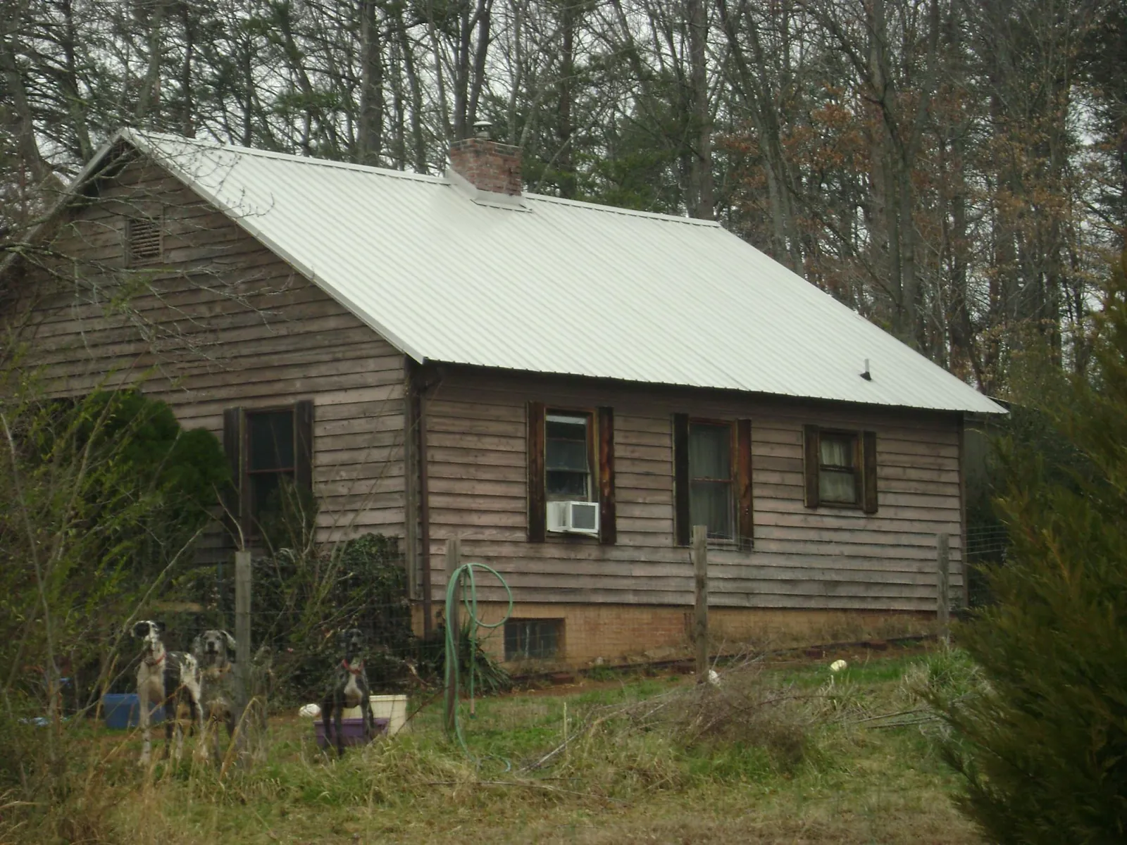 White metal roof on an old wood sided farmhouse, from a Metal Roof Installation job in Hermiston